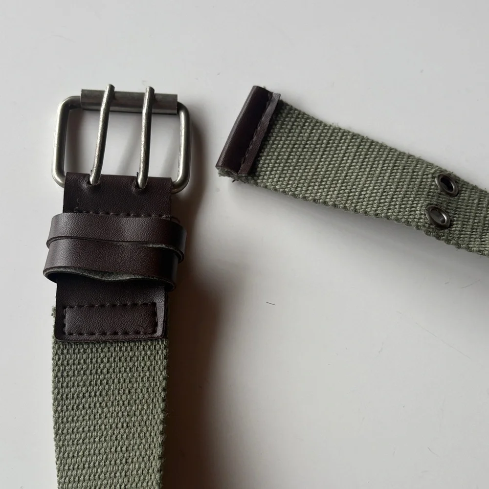 Olive Green Canvas Belt with brown accents. Silver tone hook loops.